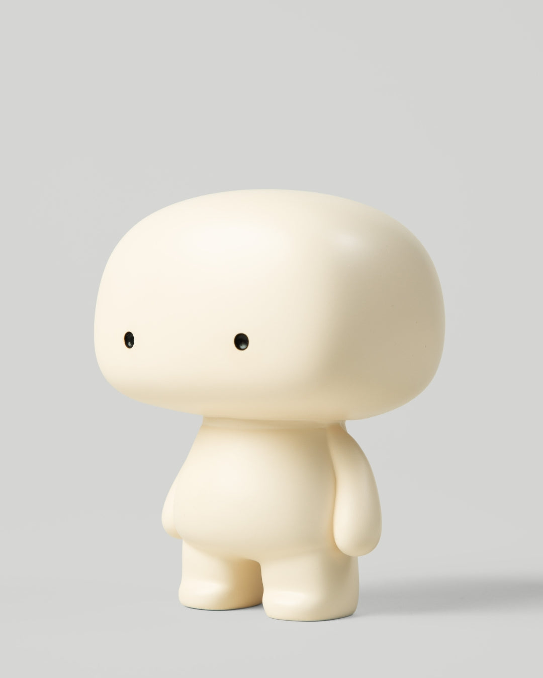 Blumo art toy figure, three-quarter view from the left, on a plain grey background
